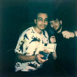 polaroid of ZAWA holding synths and Ismybro holding a camera.